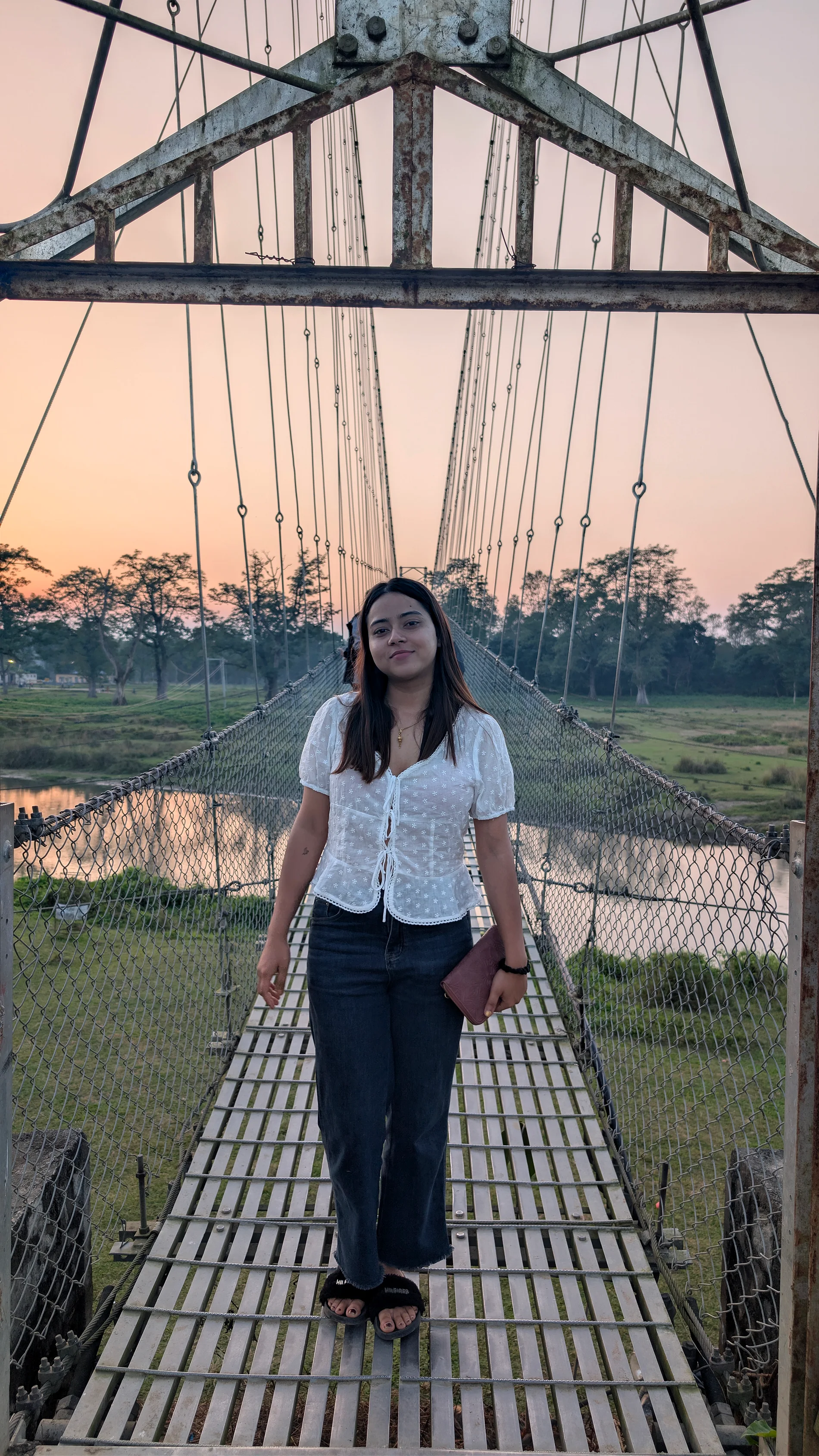 Tamanna on a footbridge at sunset
